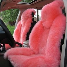 two pink furry seats in the back of a car