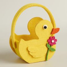 a yellow ducky shaped basket with a flower in it's beak and eyes