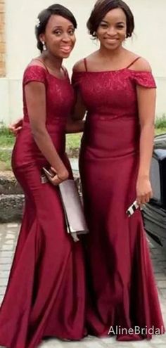 two women in red dresses standing next to each other with their arms around each other