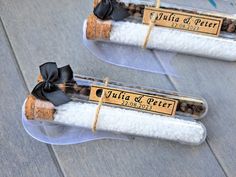 two wine corks with labels on them are wrapped in clear cellophane and ribbon