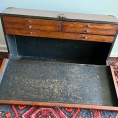 an old wooden chest sitting on top of a rug