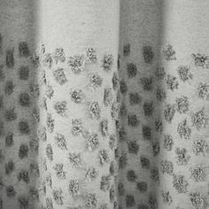 black and white photograph of curtains with holes in them