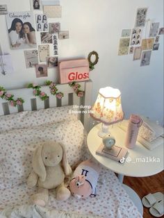 two stuffed animals sitting on a bed in a room with many pictures and decorations around it