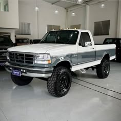 a white pickup truck parked in a garage