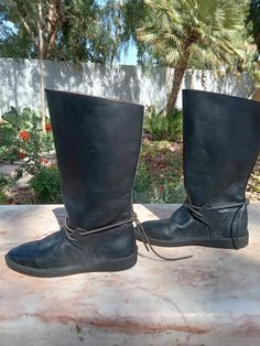 **Handmade Leather Pirate Boots** Embrace your inner swashbuckler with these beautifully crafted handmade leather pirate boots. Designed for both style and comfort, each pair features high-quality, durable leather, intricate stitching, and an authentic rustic finish. Perfect for cosplay, Renaissance fairs, or adding a bold touch to your everyday wardrobe. Walk the plank in confidence with these unique, eye-catching boots that are sure to turn heads! Available in various sizes to ensure a perfect fit. Leather Boots For Medieval Festivals, Black Leather Medieval Boots, Boots Medieval, Walk The Plank, Pirate Boots, Walking The Plank, Everyday Wardrobe, Larp, Handmade Leather