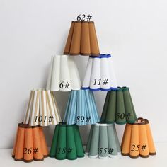 a number of different colored lamps with numbers on each lamp shade and the same color