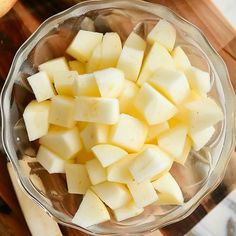 chopped potatoes in a glass bowl on a cutting board