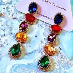 Gorgeous Beaded Crystal Drop Earrings In Extremely Vibrant, Shimmering Blue, Red, Purple, Gold & Green, & Embellished With Delicate Gold Trim, By Jewelry Designer Deepa Gurnani Whose Work Is Often Featured By Anthropologie. Absolutely Stunning Showstoppers Even More Beautiful In Person. Elegant, Lightweight & Guaranteed To Bring Compliments Whenever You Wear Them. Perfect For Casual & Dressy Attire. Designed By Deepa & Handmade According To Her Specifications By Jewelry Artisans In India, With D Bohemian Purple Chandelier Earrings For Party, Purple Bohemian Chandelier Earrings For Party, Elegant Rainbow Jewelry For Party, Elegant Multicolor Chandelier Earrings For Celebration, Elegant Rainbow Rhinestone Jewelry, Elegant Multicolor Jeweled Chandelier Earrings, Elegant Multicolor Chandelier Earrings For Festive Occasions, Rainbow Drop Earrings For Party, Rainbow Party Jewelry With Dangling Beads