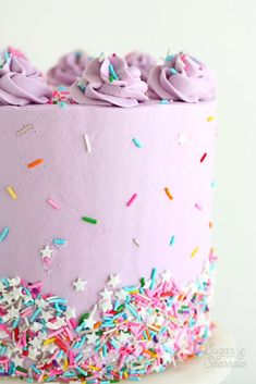 a pink cake with sprinkles and frosting