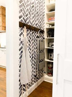 an open closet with towels hanging on hooks