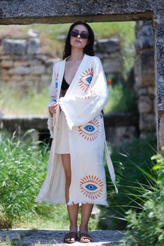 "This incredibly soft, breathable evil eye kaftan is the perfect cover-up for all your summer needs, from the beaches to picnics in the park. Made from 100% organic cotton and hand-printed with the timeless evil eye design, this Greek goddess-style kaftan will keep you protected from evil spirits and evil eyes. This kaftan is perfect for relaxing or dressing up with the ultimate ease of comfort. You can wear it around the house, on the beach, or dress it up with jeans and a T-shirt. Soft, light, and eco-friendly, it dries quickly and absorbs water better than a towel. Purpose of usage; Turkish cotton robe, spa bath, boho robe, Made of %100 Cotton, Ethnic Kaftan, Kimono Robe, Dressing gown, Boho Cover Up, Meditation Robe, Organic Cotton bathrobe, lithograph pattern, Unisex Spa robe Dries ve Bohemian Embroidered Kimono For Vacation, Long Boho Print Cover-up For Festivals, Boho Print Tunic Cover-up For Festival, Traditional Kimono For Beach Season, Traditional Festival Cover-up For Beach Season, Traditional Boho Print Kimono For Festival, White Boho Print Kimono For Festival, Hippie Printed Festival Kaftan, Hippie Embroidered Kimono For Festival