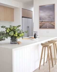 the instagram page shows an image of a kitchen with white countertops and wooden stools