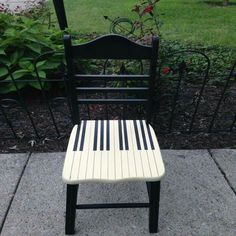 a black and white chair sitting on top of a sidewalk