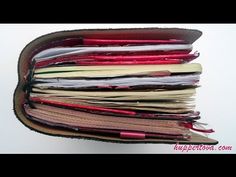 an open wallet filled with lots of different types of papers on top of each other