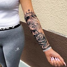 a woman's arm with a tattoo on it and a crown in the middle