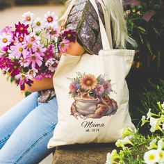 This Personalized Natural Cotton Canvas Tote Bag makes a great Gift for Mother's day, Bridal Shower, Bridal party, or a Group Gift for vacations and more! Features:  ✔ Size: Width 15", Length 16", 20" Handle   ✔  Material: Made from 100% cotton canvas, this bag is designed to withstand everyday use. The heavy fabric (12 oz/yd² or 406.9 g/m²) ensures durability while offering a natural color background that beautifully showcases the vibrant designs printed on it.  ✔ Personalization Option: Elevate your gift game by adding a personalized name to your bag! Please Note:  ⭐ To Make our designs look more natural on the Canvas Totes, the color White is not printed. The areas of the design that are white will be the Natural Color of the bag so that the design looks more natural and blended on the Mother's Day Gift Shoulder Bag, Mother's Day Gift Tote Bag, Mother's Day Tote Bag, Mother's Day Gift Bag For Travel, Library Bag, Group Gifts, Numbers Font, Grandma Gifts, Stylish Accessories