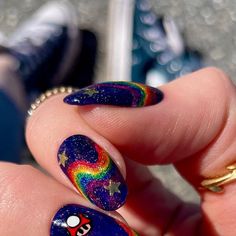 a person's hand with colorful nail art on it