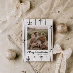 a christmas card sitting on top of a table next to ornaments