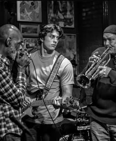 black and white photograph of three men playing instruments