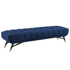 a blue velvet bench with gold legs