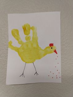 a child's drawing of a yellow bird with red dots on its body and legs