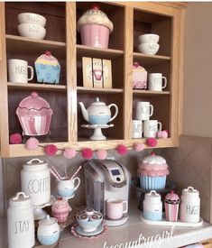 a kitchen counter topped with lots of cupcakes and other items on top of it