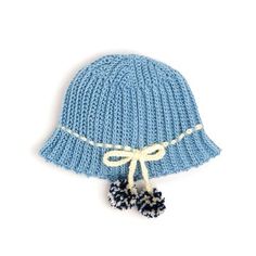 a blue knitted hat with pom - poms