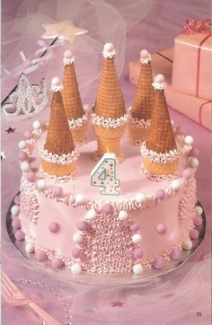 a birthday cake with three cones on top