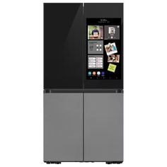 a black refrigerator freezer sitting in front of a white wall with pictures on it