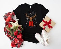 Christmas Deer Shirt, Vintage Christmas Shirt, Retro Christmas Party Shirt, Christmas Family Shirt, Winter Shirt, Holiday Season Gift Shirt Welcome to MamaBearApparell! I am a professional designer and a Mama of twins. As a professional designer, I am delighted to offer you designed t-shirts that your entire family will love and cherish, making your special moments even more beautiful. We are working to provide you with high-quality soft t-shirts and sweatshirts with trendy designs. We prioritize quality materials and stunning designs to offer you the best service possible. Our handmade items will be the perfect choice for your celebrations, vacations, graduations, or birthday & wedding parties and holidays (such as Christmas, Thanksgiving ..)  Discount available on bulk orders! Feel free Casual Christmas Festive Shirt, Black Shirt For Winter Holiday, Festive Winter Short Sleeve Shirt, Festive Short Sleeve Winter Shirt, Black Holiday Shirt, Winter Holiday Short Sleeve Shirt, Short Sleeve Holiday Shirt For Winter, Christmas Crew Neck Shirt Gift, Christmas Gift Crew Neck Shirt