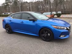 a blue car parked in a parking lot