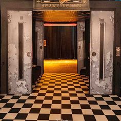 the entrance to an old theater with black and white checkered floor