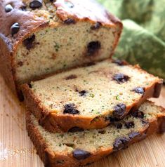 sliced loaf of fruity bread sitting on top of a wooden cutting board