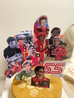 a birthday cake decorated with photos of race drivers and the number 55 on it's frosting