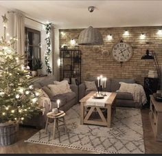 a living room filled with furniture and a christmas tree in front of a brick wall