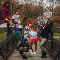 a group of people dressed in costumes on a bridge