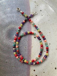 "Inspired by glass Mardi Gras beads thrown in New Orleans in the 1970s and 80s - This Semiprecious Gemstone Beaded Necklace is made with high quality multicolored stones measuring 3mm and 4mm round and approximately 4x2mm and 5x3mm diameter rondelle.   The color and stone combination of this necklace is thoughtfully designed with love by me. I choose each stone carefully and hand string all components on flexible wire which creates an extremely durable and comfortable necklace that will not stre Colorful Natural Stone Beaded Necklaces With Round Beads, Rainbow Beaded Necklaces With Natural Stones, Colorful Beaded Necklaces With Natural Stones, Multicolor Beaded Crystal Necklaces For Healing, Rainbow Gemstone Beaded Necklaces For Healing, Colorful Gemstone Beaded Necklaces With Round Beads, Colorful Gemstone Beaded Necklaces, Multicolor Crystal Necklaces With Gemstone Beads, Multicolor Round Crystal Necklaces With Gemstone Beads