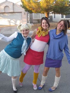 three women in costumes posing for the camera