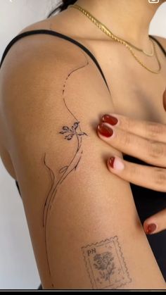 a woman's arm with a tattoo on the back of her shoulder and hand