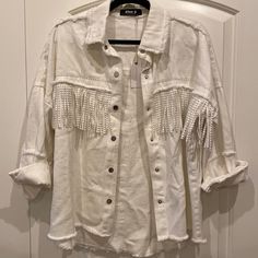 Nwt Stitch + Feather Shacket. White Oversized Jean Jacket With Fringe. Silver Studded Accents On Fringe And Collar. Button Up Shacket. Intentionally Minimal Frayed Bottom And Along Collar. New With Tags, Never Worn And In Perfect Condition. Blue B Brand But Bought From Stitch & Feather (Stitch And Feather) Boutique. Size Small. Please Leave Any Questions Below. Offers Are Welcomed:) I Can Ship Asap Oversized Long Sleeve Fringe Outerwear, Casual White Outerwear With Frayed Hem, Spring Cream Outerwear With Fringe, Cream Fringe Outerwear For Spring, Spring Cream Fringe Outerwear, Cream Long Sleeve Fringe Outerwear, Jean Jacket With Fringe, Long Distressed Denim Jacket, Trucker Jacket Women