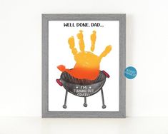 a hand print is on the wall next to a frame with an image of a grill that says, hell donee dad