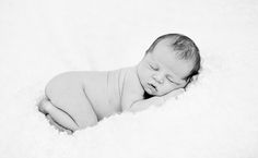 a black and white photo of a sleeping baby