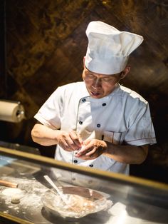 a chef is preparing food in the kitchen