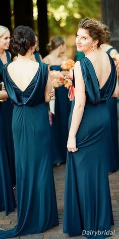 the bridesmaids are dressed in dark blue dresses and one is looking at her