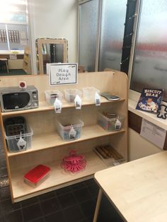 a display case with various items on it in a store or office area, including books and other things