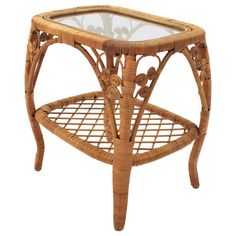 a wicker table with glass top on white background