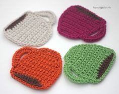 four crocheted items are arranged in the shape of purses, one with an eye patch