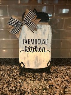 a sign that says farmhouse kitchen with a bow on the front and back of it