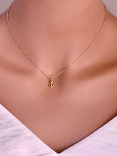 This 14-karat yellow gold anchor charm is set with one .003-ct. round white diamond (SI-I1 grade/G,H,I color; .003-ct) at the bottom anchor point. The charm is flat on the back and brightly finished on both sides. Inspirational Necklace You are Strong Necklace - Warrior Necklace - Survivor gift -Encouragement Gift -Tiny 14k solid gold anchor necklace Tiny 14k Real Gold Anchor Pendent from a delicate chain. Dainty little anchor necklace made of solid 14KT Yellow Gold on a delicate solid 14kt Yell Elegant Yellow Gold Anchor-shaped Necklaces, Elegant Anchor-shaped Jewelry Gift, Gold Anchor Jewelry Gift, Anchor Shaped Charm Jewelry As Gift, Gold Anchor Jewelry For Anniversary, 14k Gold Anchor Necklace Gift, 14k Gold Anchor Necklace As Gift, 14k Gold Anchor Shaped Jewelry Gift, Diamond Charm Necklace