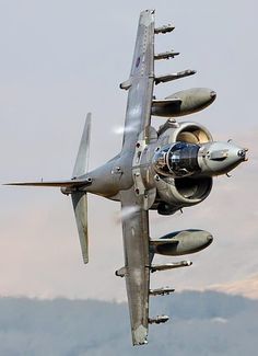 a fighter jet flying in the sky with its landing gear down and it's engine out